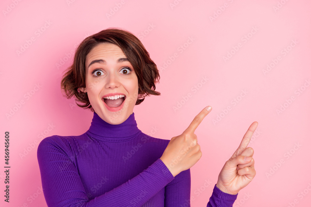 Photo of cool brunette young lady point empty space wear violet jumper isolated on pink color background Photo of cool brunette young lady point empty space wear violet jumper isolated on pink color background