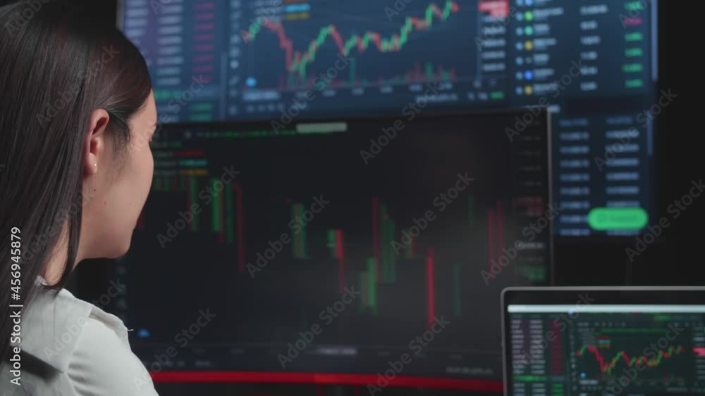 Asian Female Stock Market Broker Working On Computer With Analyzing Graphs On Multiple Computer Screens At Background
Asian Female Stock Market Broker Working On Computer With Analyzing Graphs On Multiple Computer Screens At Background