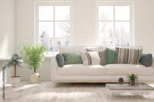 White living room with sofa and winter landscape in window. Scandinavian interior design. 3D illustration