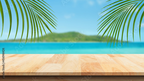 Wood table against scenic view of the sea and blue sky. For your product placement or montage with focus to the table top in the foreground