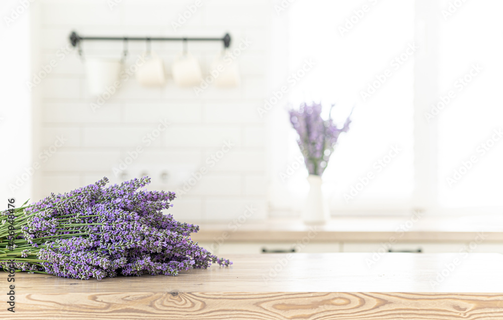 A bouquet of lavender in the interior of a stylish kitchen. Vertical frame mockup on a wooden table. - obrazy, fototapety, plakaty 