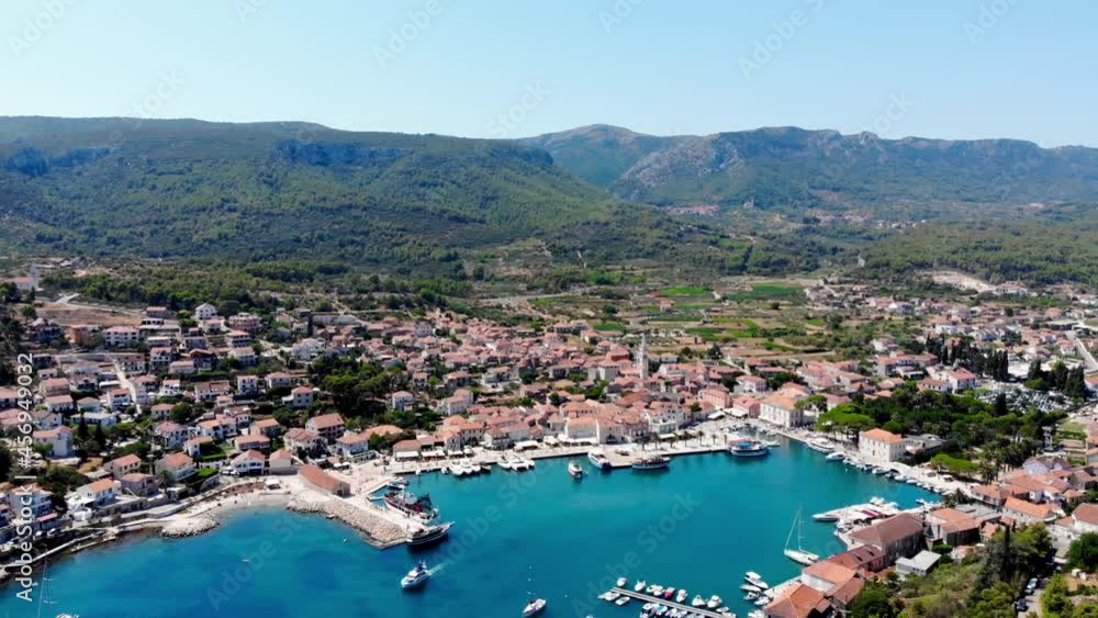 Drone shot on the Croatian resort island of Hvar in the Adriatic Sea. View from the drone to the port. Boats and ships on the shores of the Adriatic Sea in Croatia. Mountains on the island of Hvar. Drone shot on the Croatian resort island of Hvar in the Adriatic Sea. View from the drone to the port. Boats and ships on the shores of the Adriatic Sea in Croatia. Mountains on the island of Hvar.