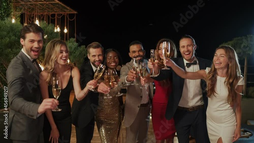 Group of people toasting with champagne and spending time on party 