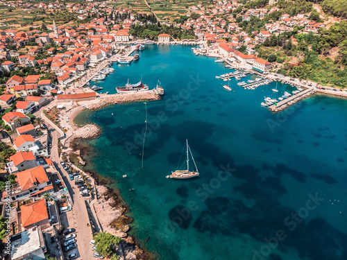 Drone shot on the Croatian resort island of Hvar in the Adriatic Sea. View from the drone to the port. Boats and ships on the shores of the Adriatic Sea in Croatia. Mountains on the island of Hvar. 