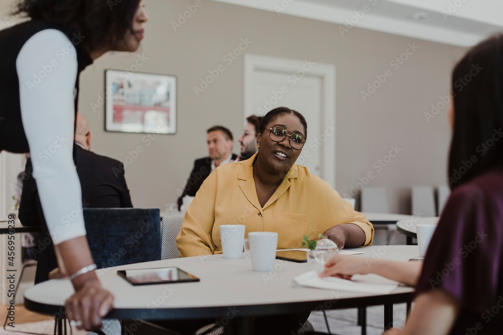 Businesswoman discussing with female employees in education class Businesswoman discussing with female employees in education class
