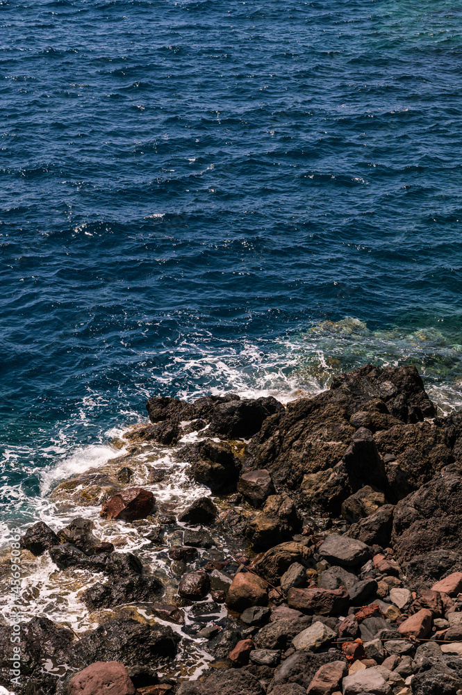 Stone beach of the sea. Top view of the waves and rocks. Close-up. Nature background. Stone beach of the sea. Top view of the waves and rocks. Close-up. Nature background.