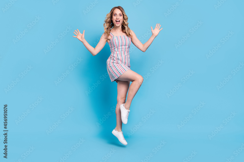 Full length body size photo woman in dress jumping high amazed isolated pastel blue color background