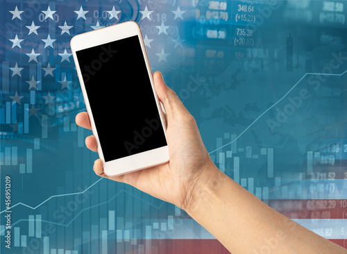 Holding mobile phone to online trade finance global business with USA America flag, stock market investment