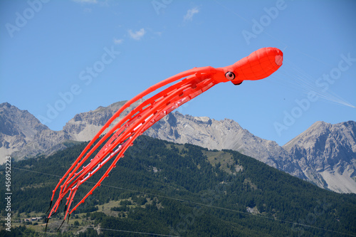 Magical kite with the strangest shapes fly in the wind of the Alps. photo