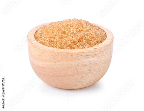 Brown cane sugar in wooden bowl on white background
