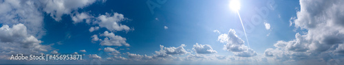 panorama of blue sky with clouds and sun