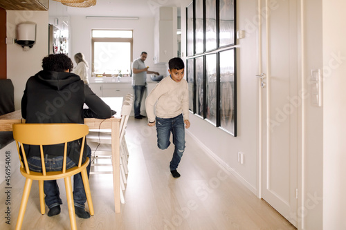 Autistic boy running in living room photo