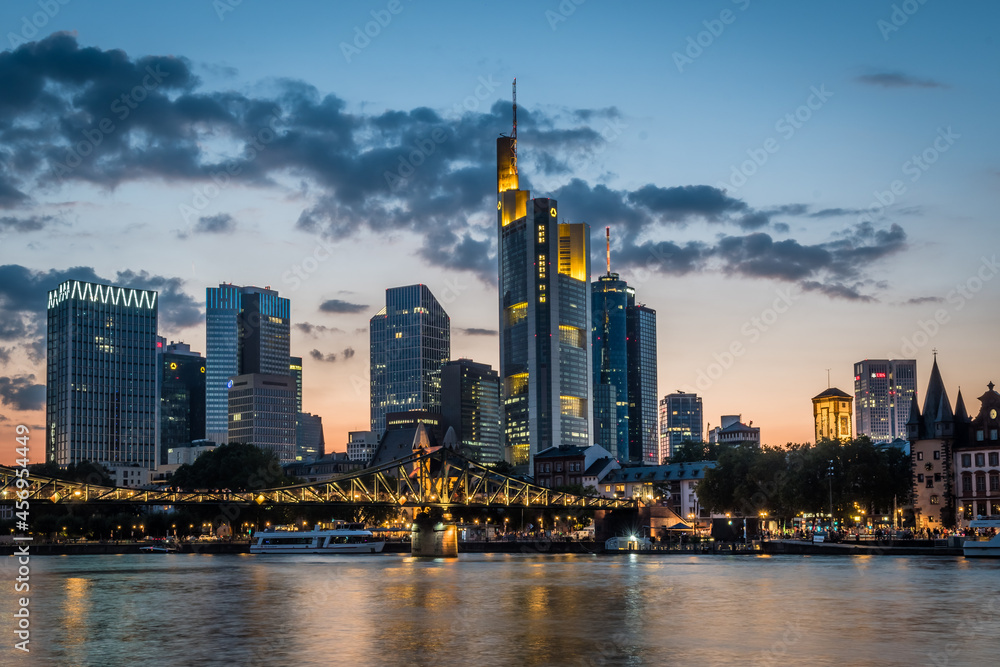 Illuminated skyline of Frankfurt at the bank of Main river after sunset