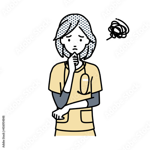 立って手をあごにあてて困っている看護師の女性