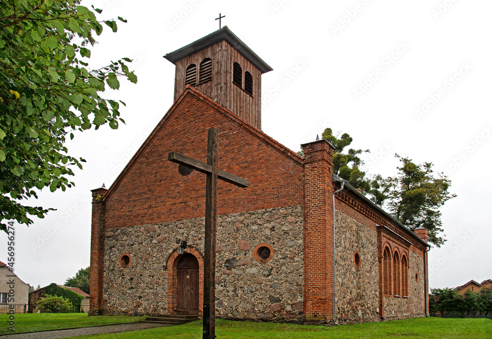 General view and close-up of architectural details of the former Evangelical church built in 1855 from field stone in the village of Rybno in warmia in Poland.