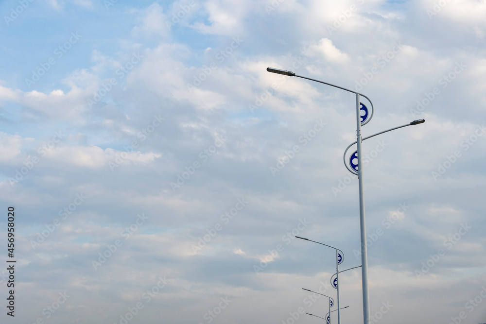 The city street lights are under the blue sky.