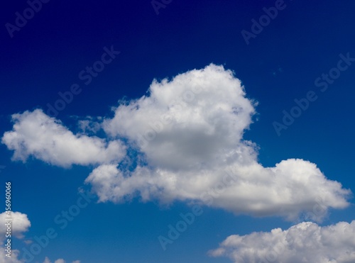 The white cloudscape in the bright blue sky.