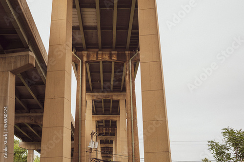 Looking up view from underneath highway overpasses stretching into the distance. 