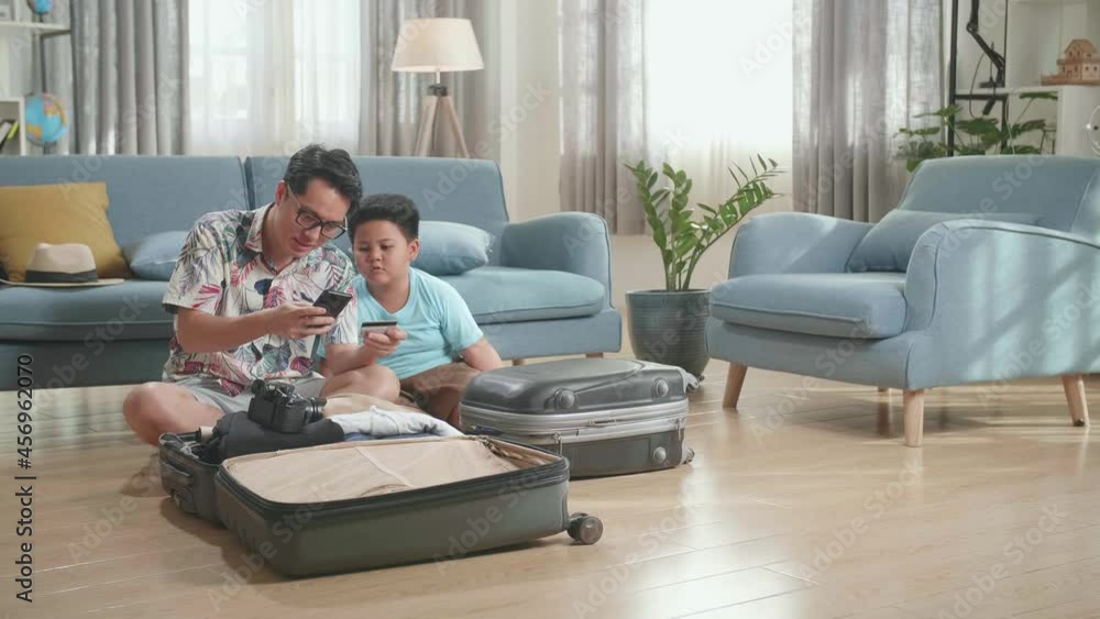 Asian Father Buys Tickets For Cheap Flights On Smartphone With Credit Card Before Go To Travelling
Asian Father Buys Tickets For Cheap Flights On Smartphone With Credit Card Before Go To Travelling