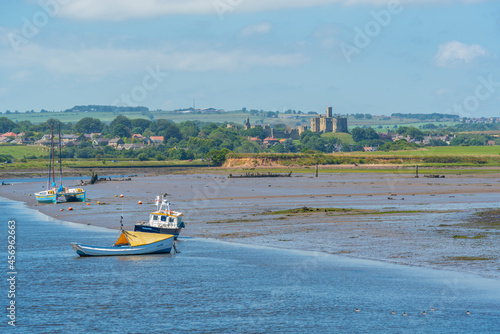 View of Warkworth Castle and boats on River Coquet from Amble, Morpeth, Northumberland photo