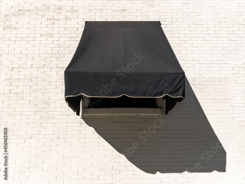 Black Awning on White Brick Wall