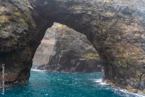 Stunning boat ride among the steep bird cliffs, caves, narrow straits and grottoes of Vestmanna, Streymoy island, Faroe Islands
