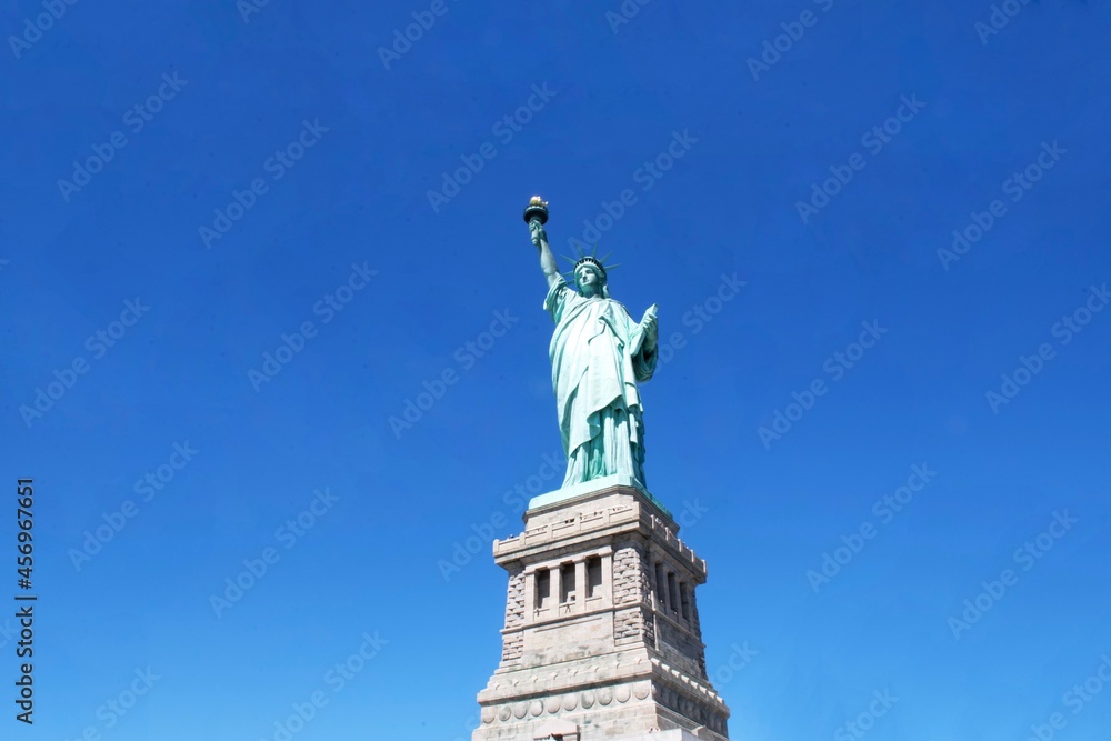 The Statue of Liberty in Liberty Island, United States, in daylight, taken at upward angle.