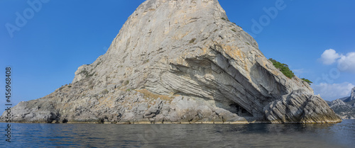 Stony coast of Crimea. Mount Koba Kaya. View from the sea. On the right is a grotto named after Prince Golitsyn. panoramic view of the coastline of Mount Koba Kaya.