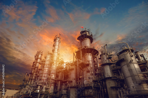 Petrochemical industrial plant on sunset sky background photo