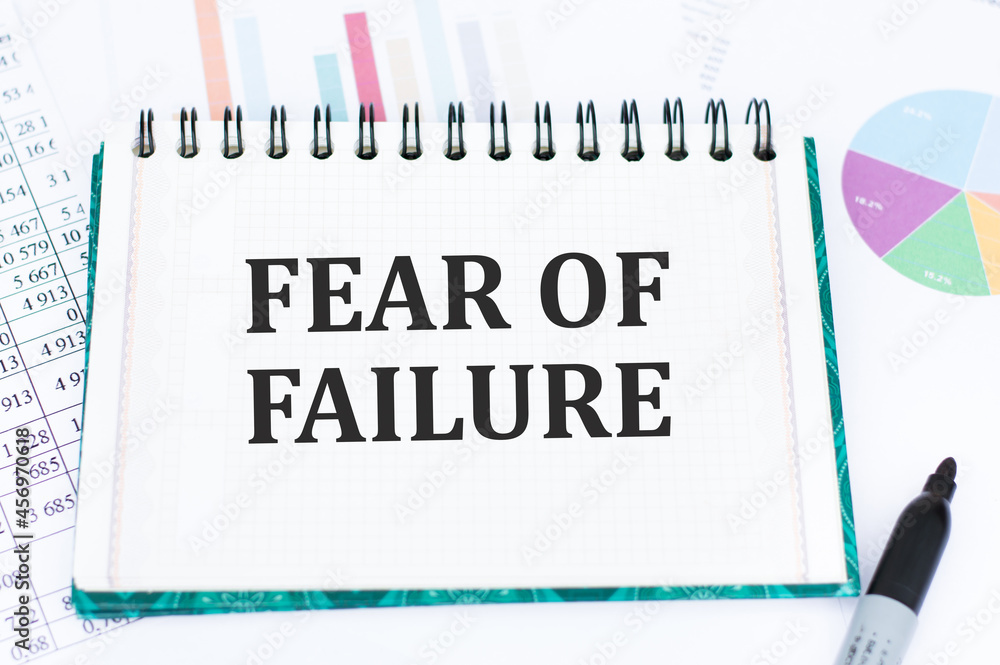 Text Fear of Failure on notepad on color charts. Text Fear of Failure on notepad on color charts.