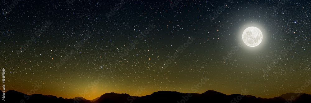 month on a background stars the sky shines over the mountains