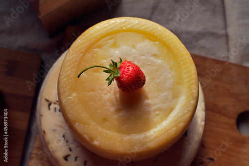 Two heads of cheese and strawberry on the table top view closeup