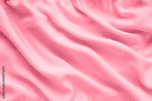 Pink silk texture, abstract background luxury fabric with wavy folds
