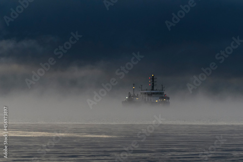 Vessel restricted in her ability to manoeuvre under way using engine at night time. Vessel engaged in dredging. Dredger working at sea. Collision regulations.