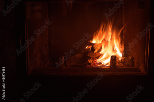 dark fireplace with burning wood