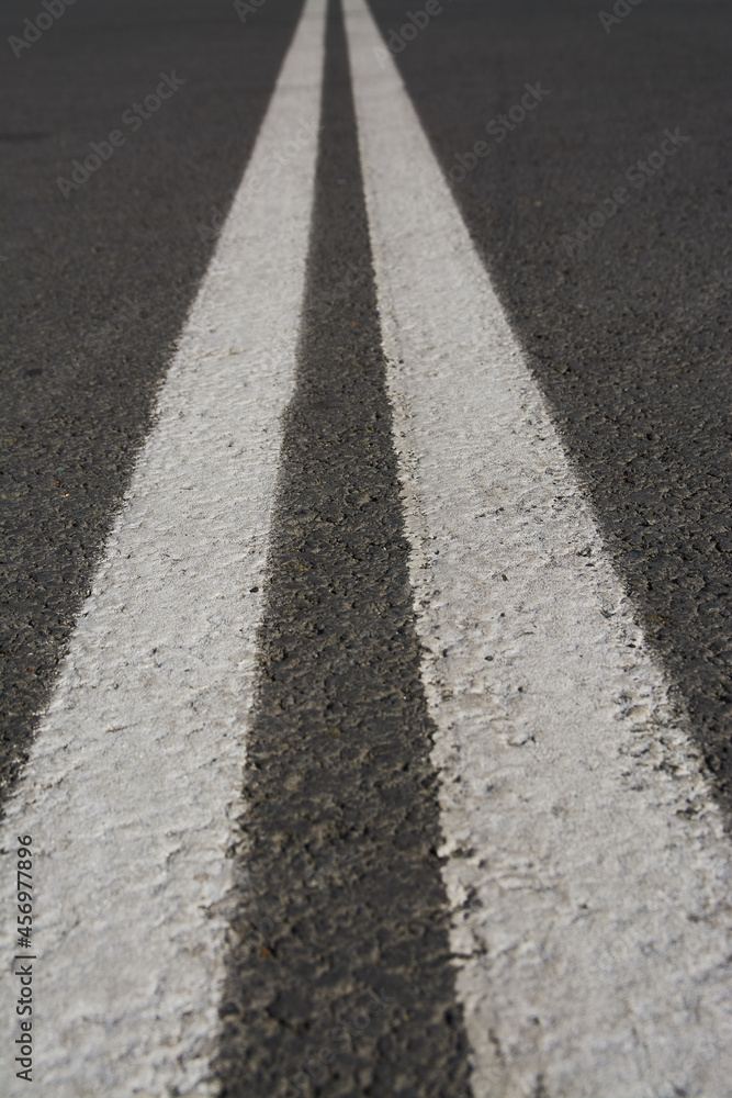 White double dividing strip on the road. Perspective.