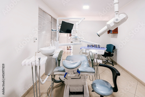 Room of a dental clinic with machinery and a stretcher.
