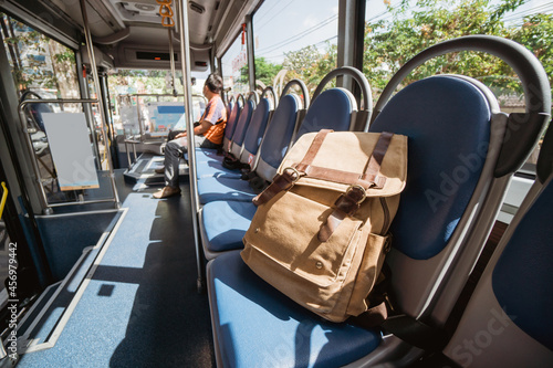 Fotografía One lost bag or backpack lie on bus seat