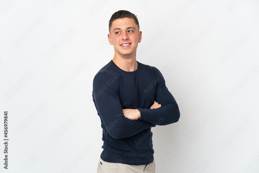 Young caucasian man isolated on white background with arms crossed and happy Young caucasian man isolated on white background with arms crossed and happy
