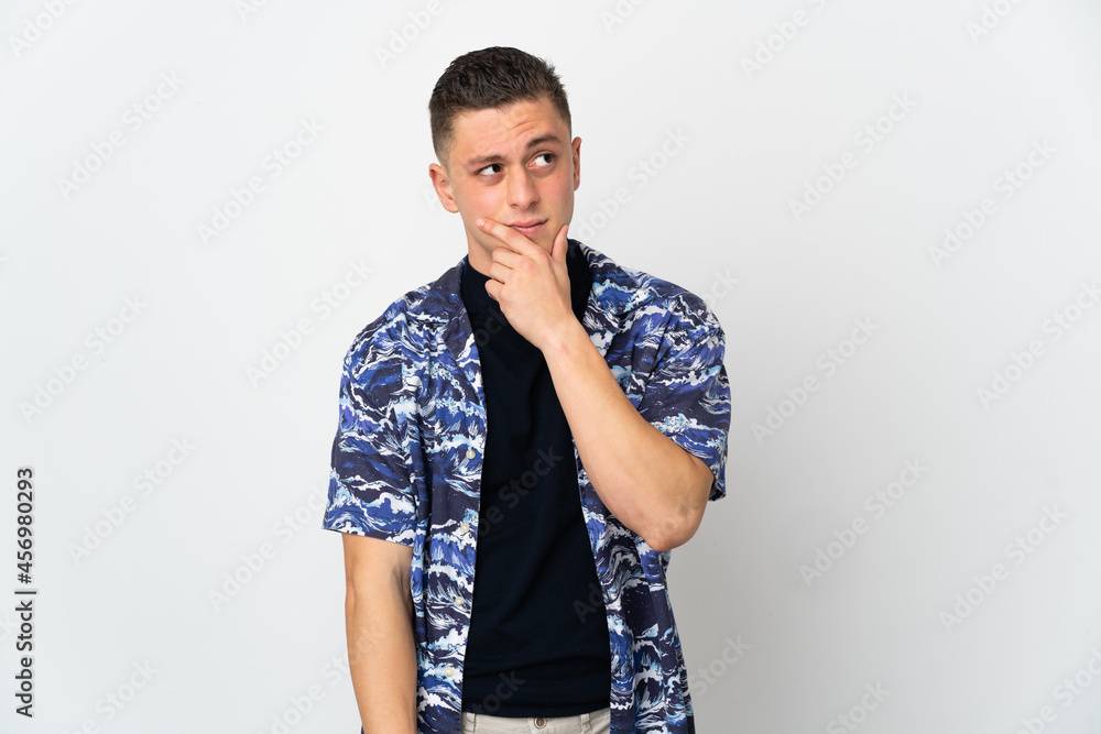 Young caucasian man isolated on white background having doubts and with confuse face expression Young caucasian man isolated on white background having doubts and with confuse face expression