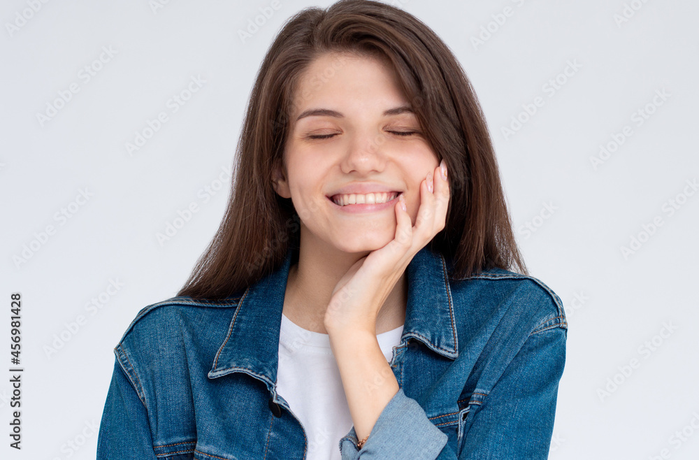 Beautiful caucasian woman dreamy smiling with eyes closed, has hand under chin, standing relaxed and happy against white background. Copy space Beautiful caucasian woman dreamy smiling with eyes closed, has hand under chin, standing relaxed and happy against white background. Copy space