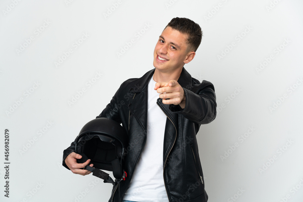 Caucasian man with a motorcycle helmet isolated on white background pointing front with happy expression Caucasian man with a motorcycle helmet isolated on white background pointing front with happy expression