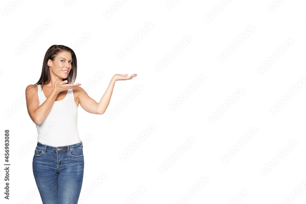 Young beautiful woman on isolated background amazed and smiling at camera while presenting with hand. Young beautiful woman on isolated background amazed and smiling at camera while presenting with hand.