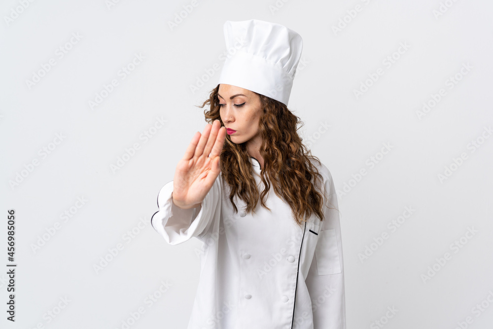 Young chef woman isolated on white background making stop gesture and disappointed Young chef woman isolated on white background making stop gesture and disappointed