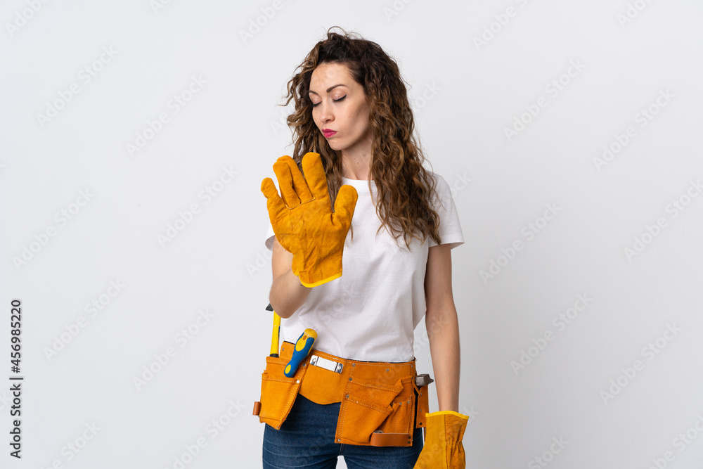 Young electrician man isolated on white background making stop gesture and disappointed Young electrician man isolated on white background making stop gesture and disappointed