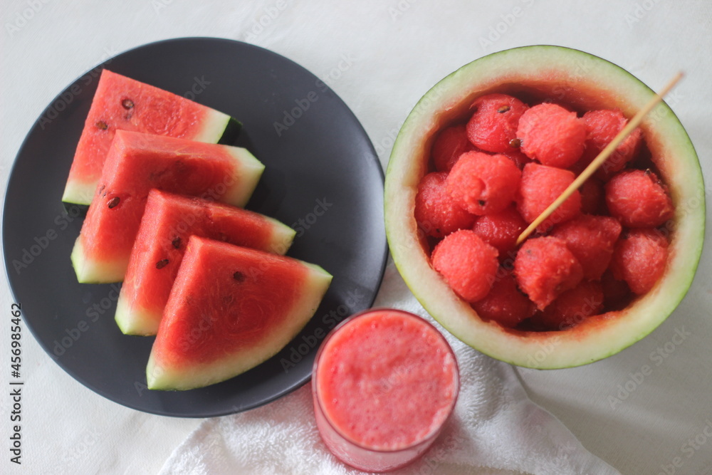 Fresh watermelon slices. Its good to keep your body cool from the summer heat. Shot along with water melon scoops and juice Fresh watermelon slices. Its good to keep your body cool from the summer heat. Shot along with water melon scoops and juice