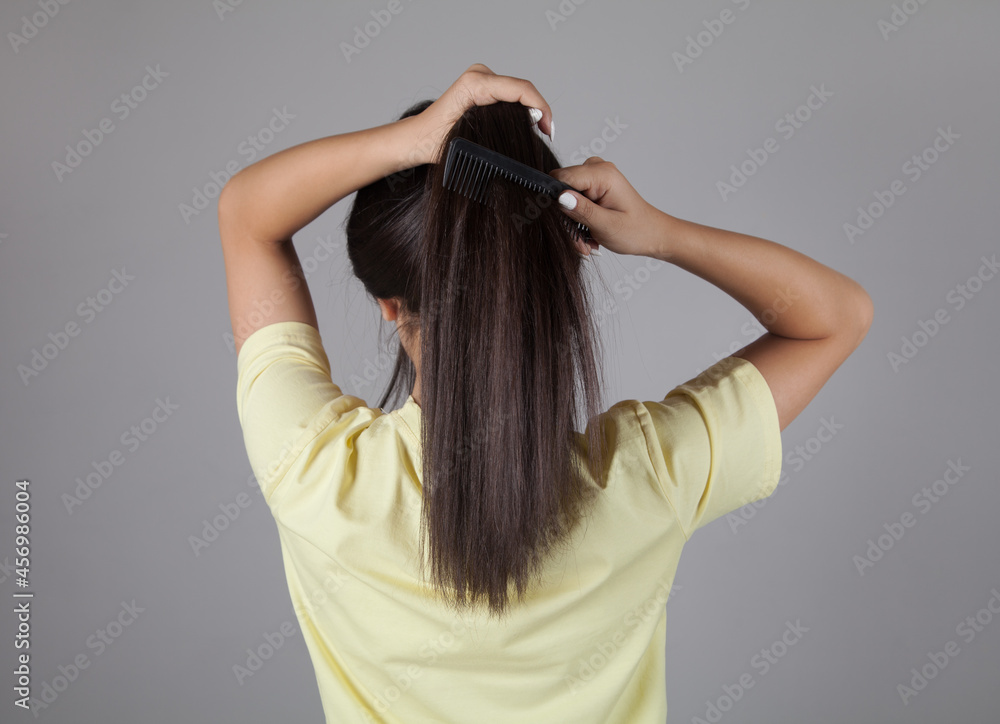 Woman combing her hair. Beautiful hair concept. Woman combing her hair. Beautiful hair concept.