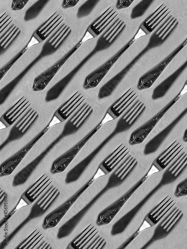 Creative fork pattern with their shadows. Cover for cookbook. Kitchen wallpaper. Fork background.