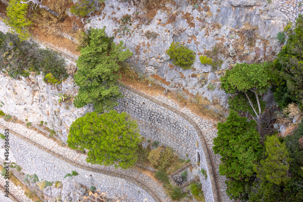 Rocky shoreline on the Tyrrhenian Sea nearby Marina Piccola, view of the footpath Via Krupp, Capri Island, Italy