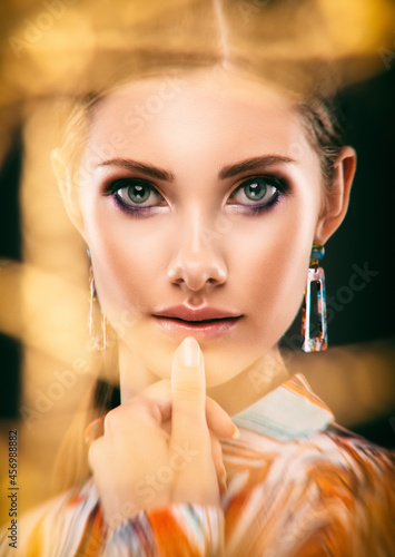 Portrait of a beautiful elegant girl with smokey eye makeup. Face close-up.  Double exposure.